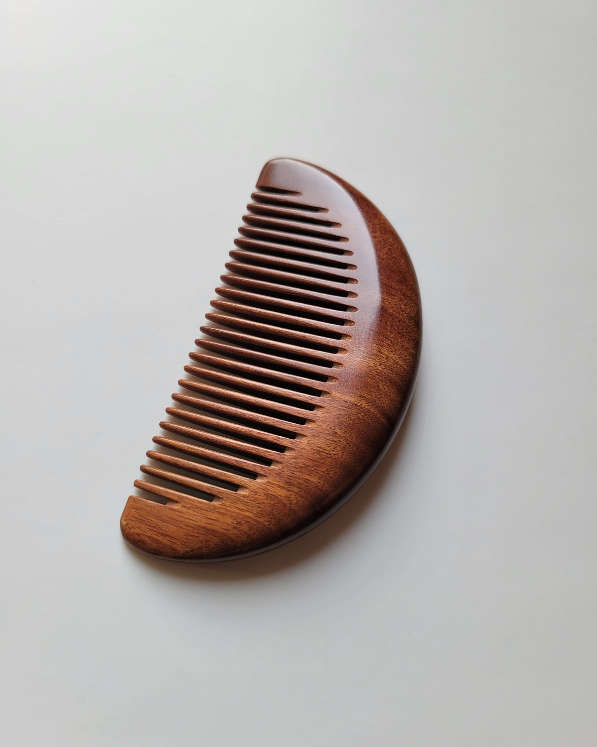 Handcrafted African Mopane comb with drawstring gift bag, a compostable self-care gift for birthdays and holidays⠋