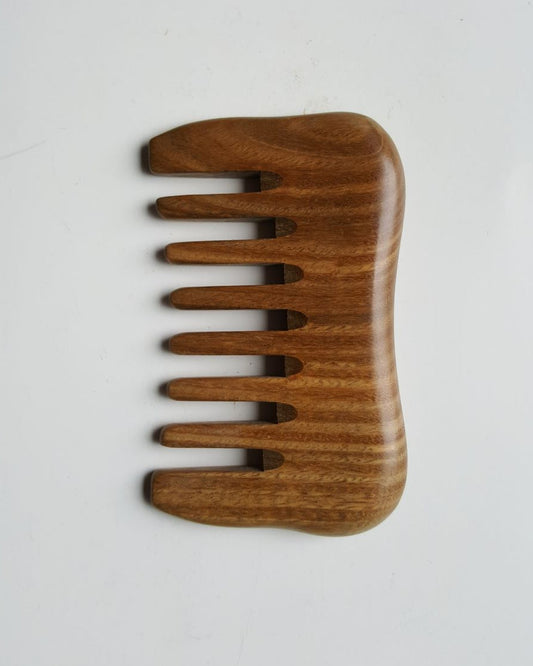 A small detangling sandalwood comb, travel size with carrying bag