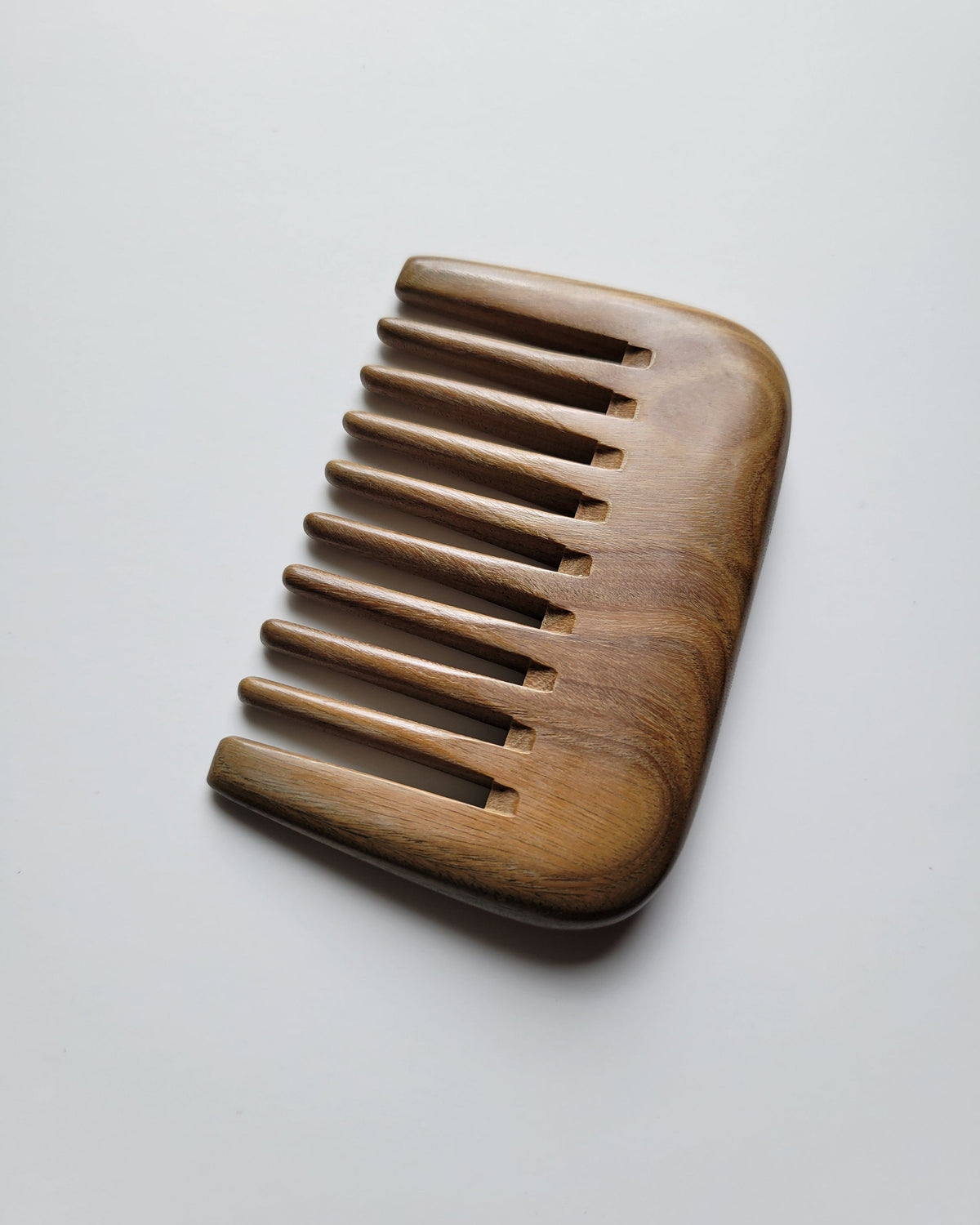 Handcrafted green sandalwood comb — pocket-sized detangling tool, self-care gift for women and men