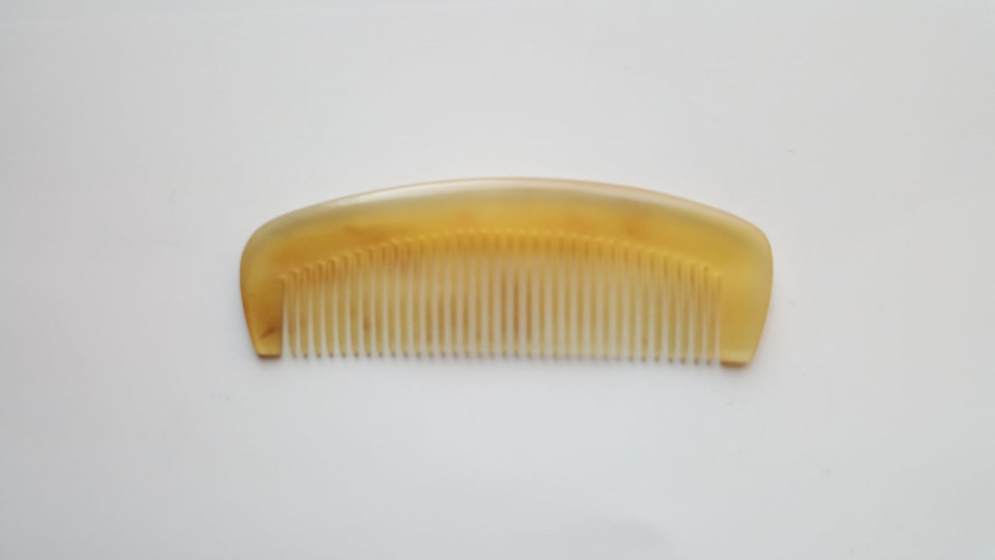 minimalist sheep horn comb with a curved shape and fine teeth for short hair and mustache.