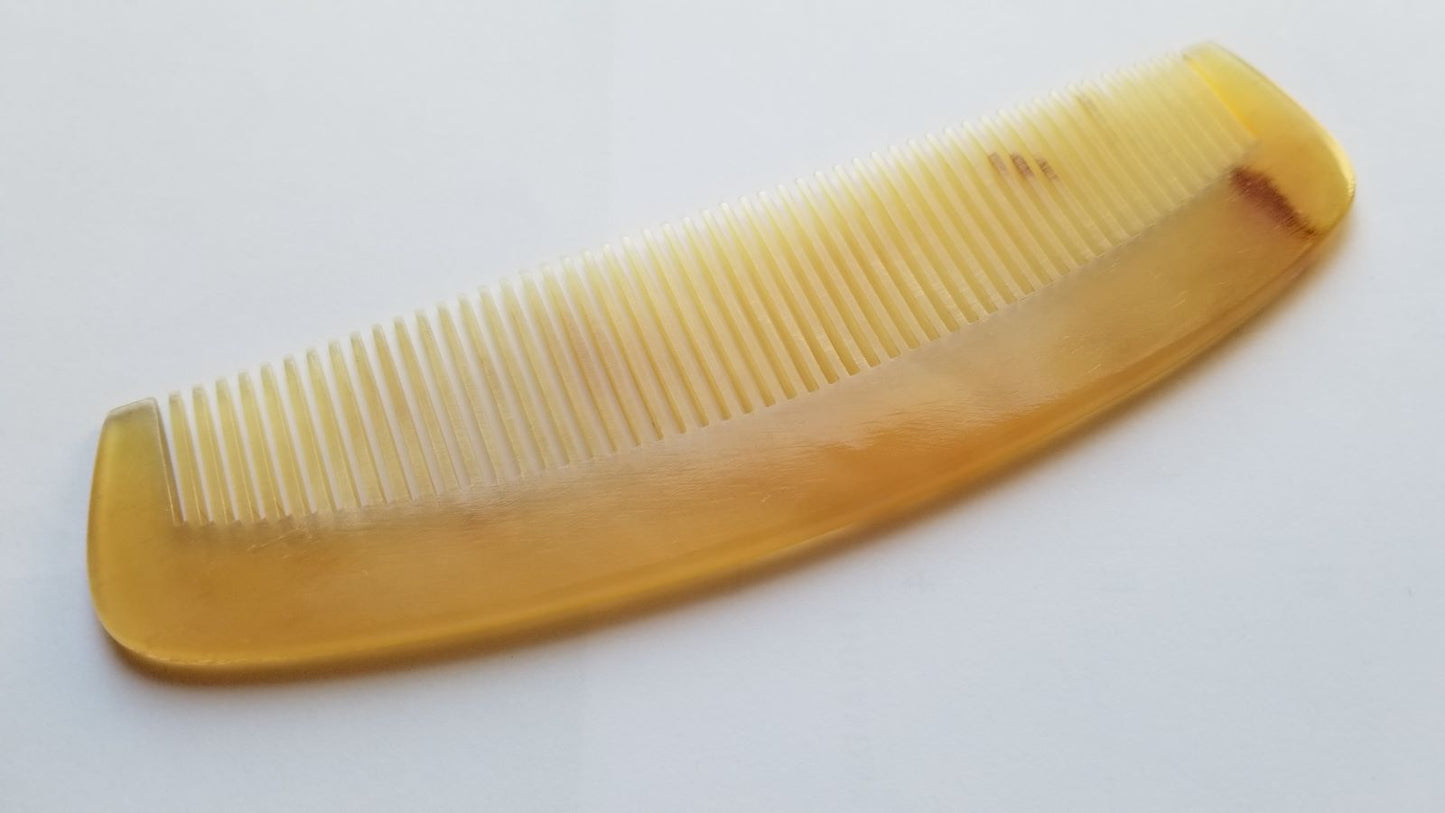 A vintage style curved comb made of sheep horn. The comb has fine teeth and a smooth, polished surface. It helps to reduce static and distributes hair oil naturally. Unique Gift for mother's Day
