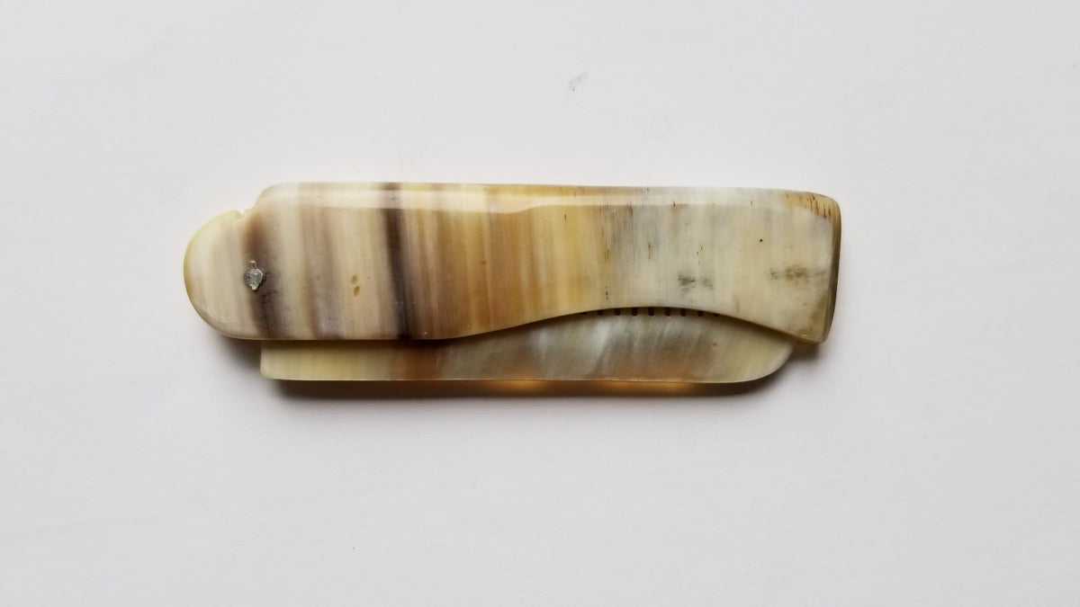 Folding Yak Horn Comb side view — light brown horn, fine teeth one side, smooth handle reverse