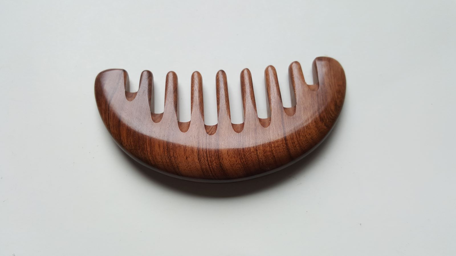 African Mopane half moon comb, reddish-brown hardwood with dark grain stripes, extra wide teeth, handcrafted wood hair comb | Arakicrafts
