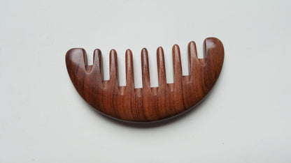 Half moon shaped African Mopane comb, ergonomic curved spine, single-piece hardwood construction for comfortable palm grip | Arakicrafts