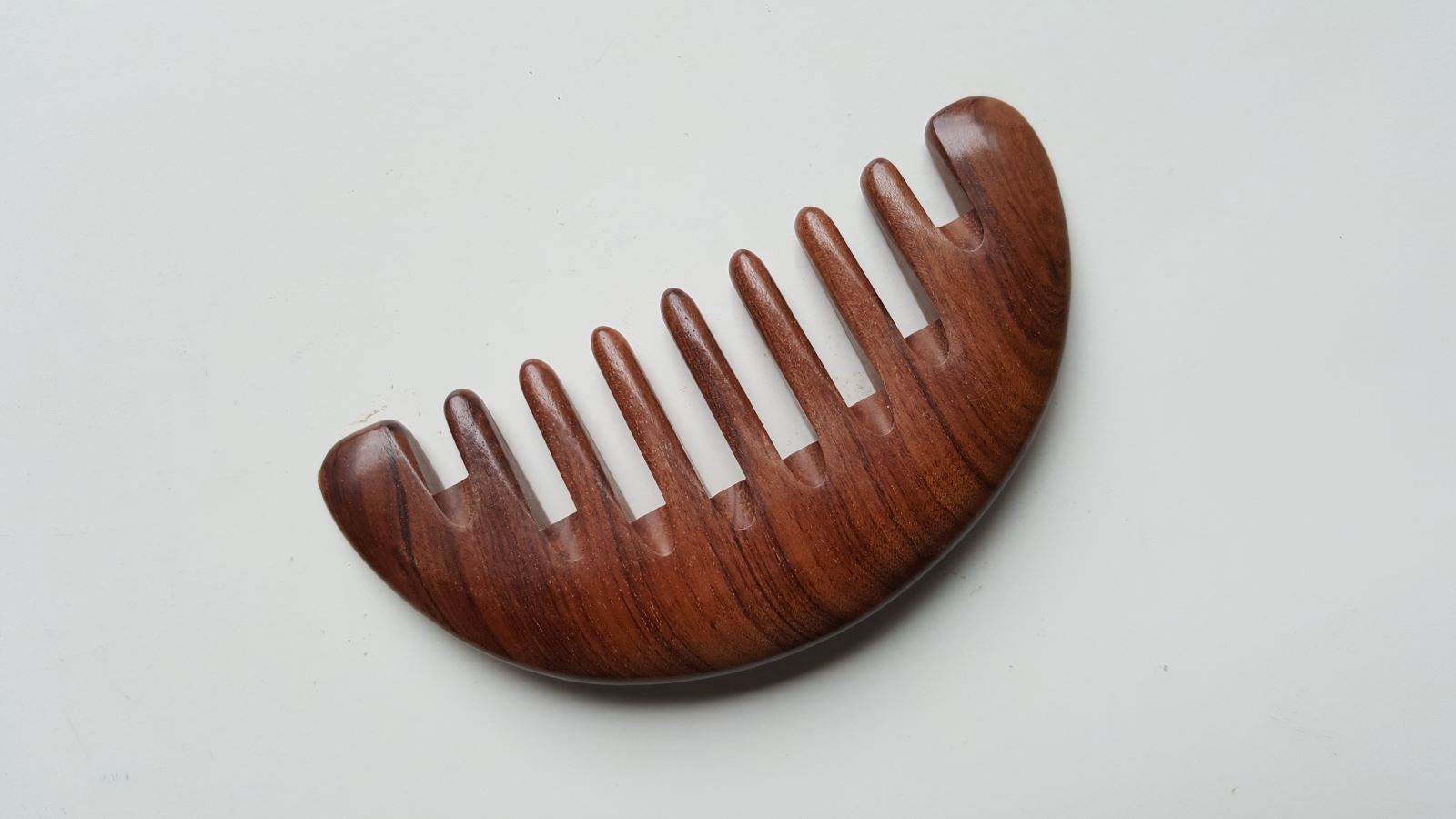 Convex arched back of African Mopane half moon comb, smooth polished surface, pocket-sized wide tooth grooming tool | Arakicrafts