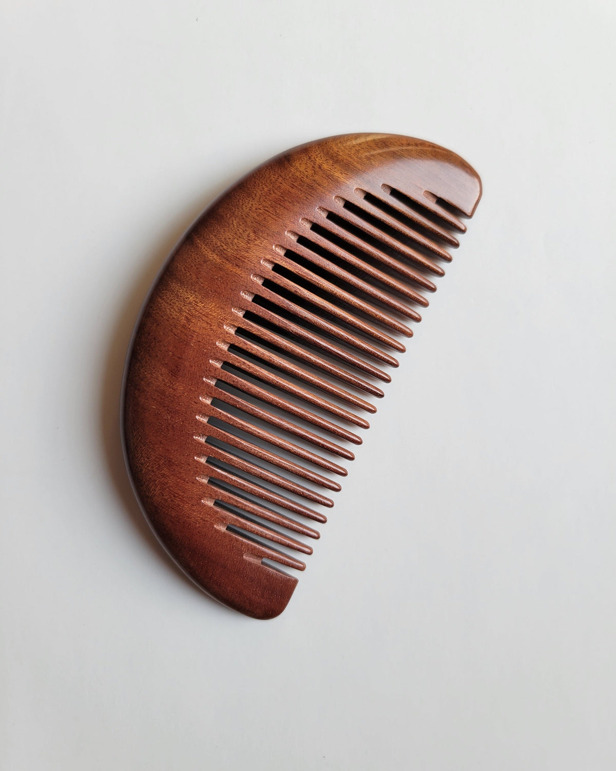 Fine-tooth wood comb with 0.15 cm spacing for gentle detangling of fine hair and beards
