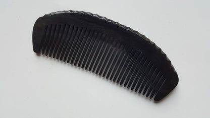 buffalo horn comb with ergonomically designed handle with organic dent forms inspired by nature