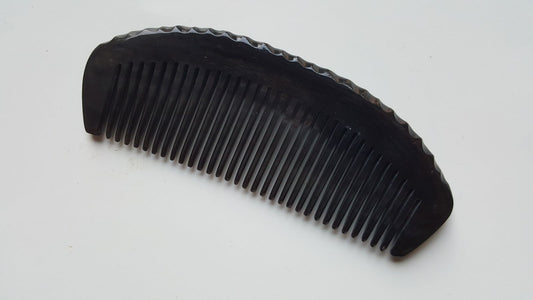 buffalo horn comb with ergonomically designed handle with organic dent forms inspired by nature