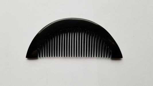 Half-moon buffalo horn comb with fine teeth facing down, full silhouette on neutral background — Arakicrafts