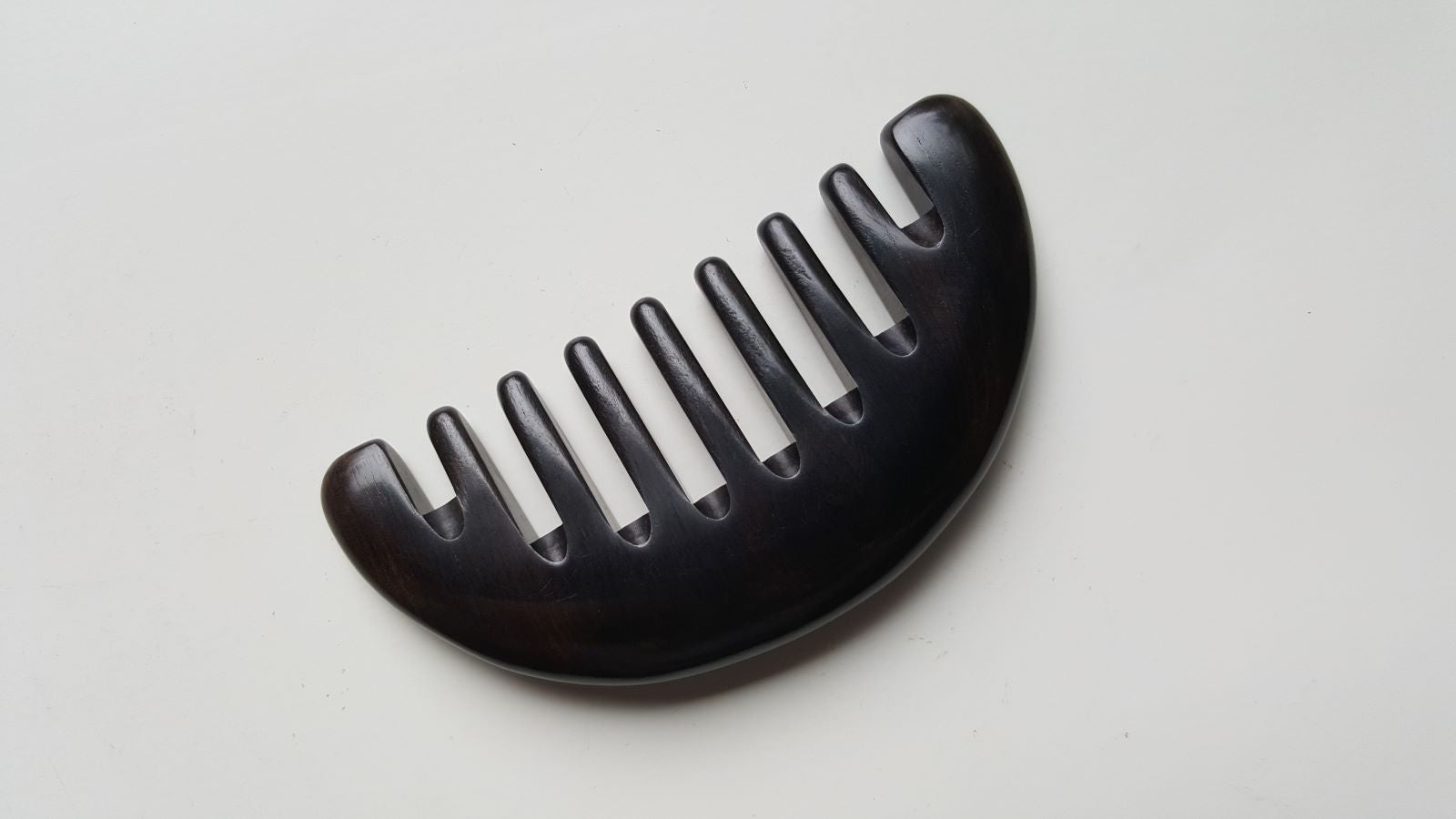 Convex arched spine of African Ebony half moon comb, single-piece hardwood construction, comfortable palm grip | Arakicrafts

