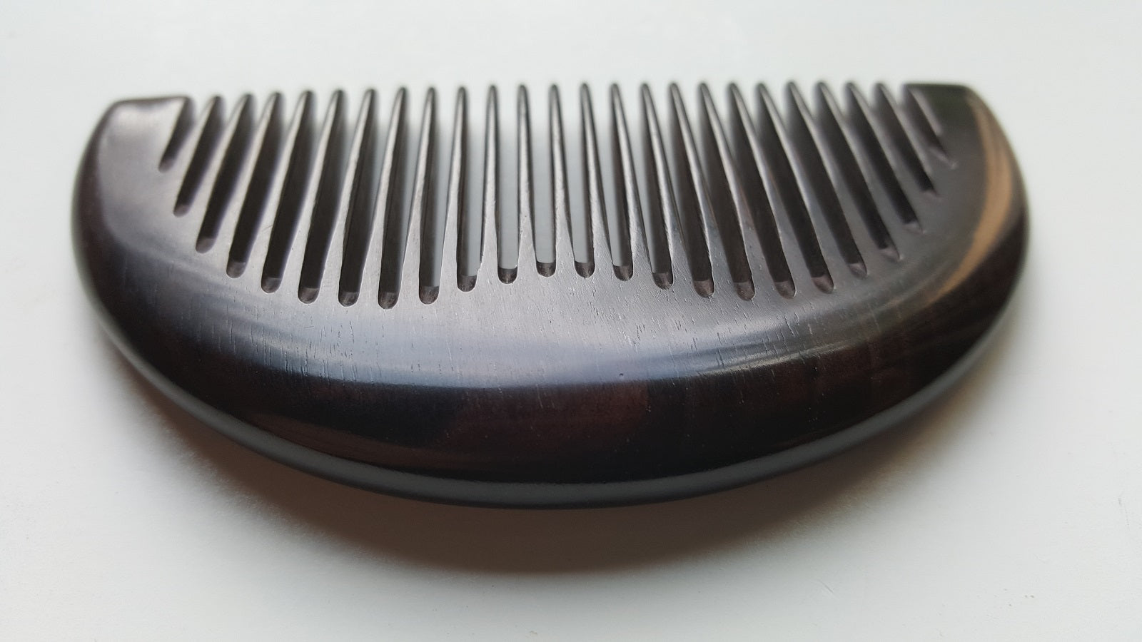 African Ebony half-moon pocket comb with drawstring gift bag, flat lay — a signature gift for him — Arakicrafts