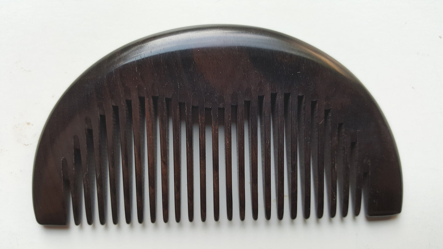 Araki half-moon wood comb in African Ebony, flat lay overhead view showing symmetrical silhouette — Arakicrafts