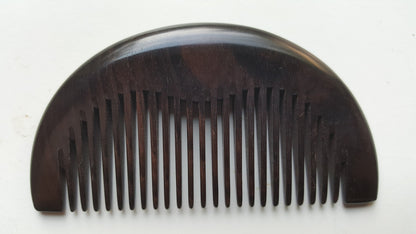 Araki half-moon wood comb in African Ebony, flat lay overhead view showing symmetrical silhouette — Arakicrafts