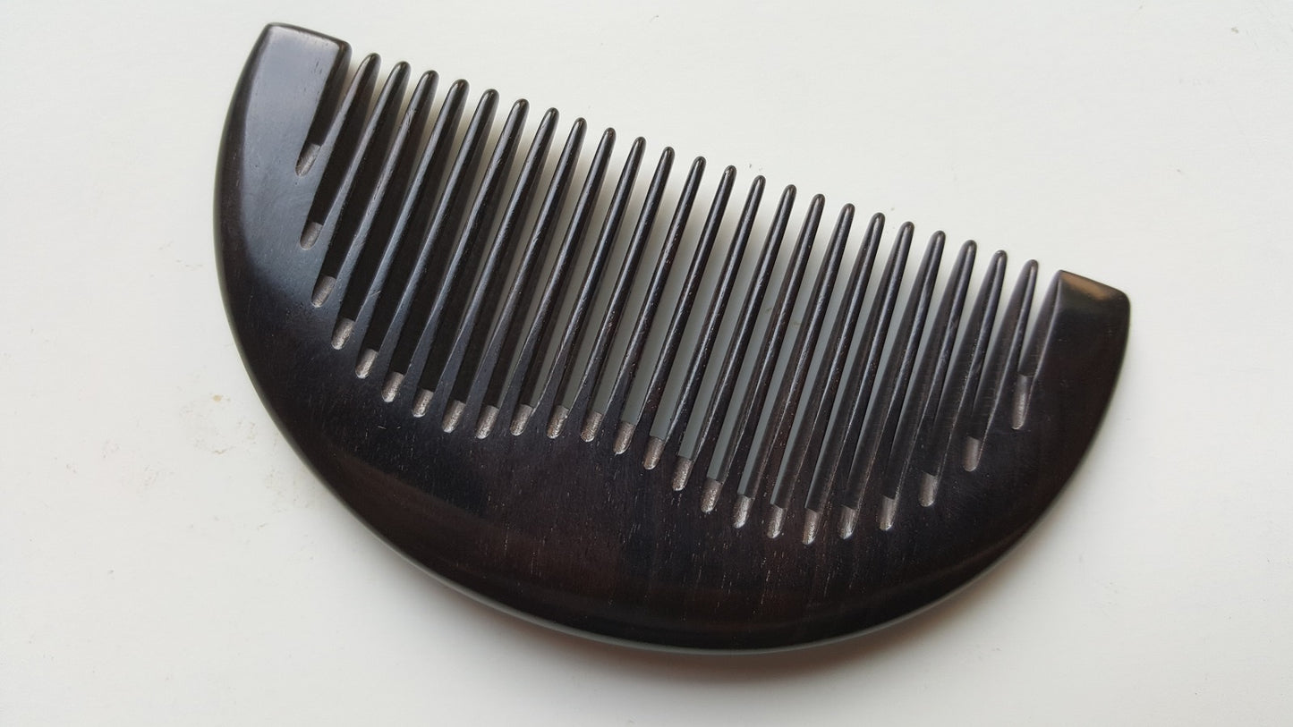 Close-up flat lay of fine teeth on jet-black African Ebony half-moon comb — 0.15 cm tooth spacing — Arakicrafts