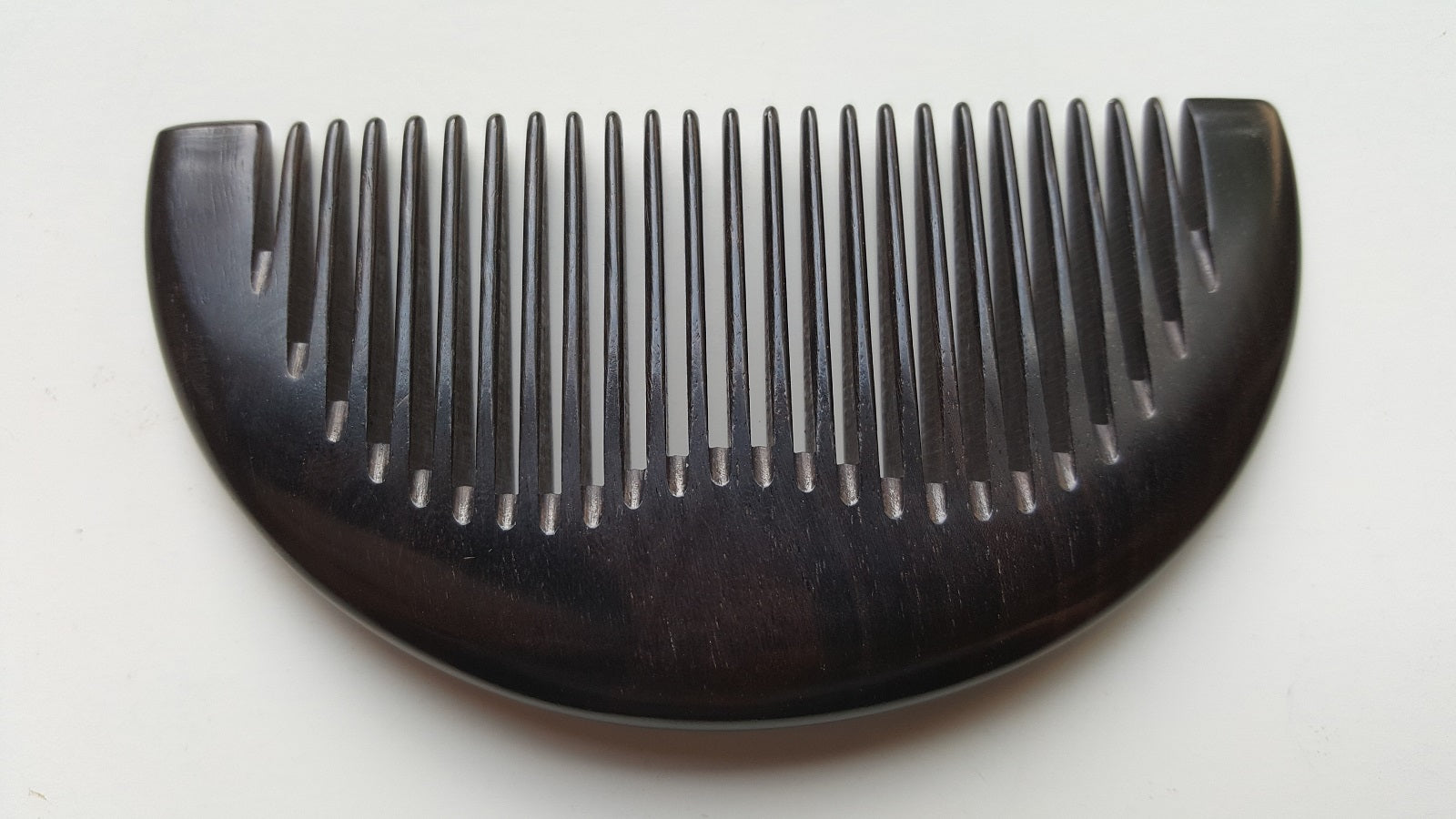 Jet-black African Ebony half-moon pocket comb, flat lay front view — Arakicrafts