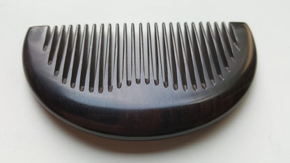 Minimalist half-moon hardwood comb for beard grooming and everyday carry, flat lay — Arakicrafts