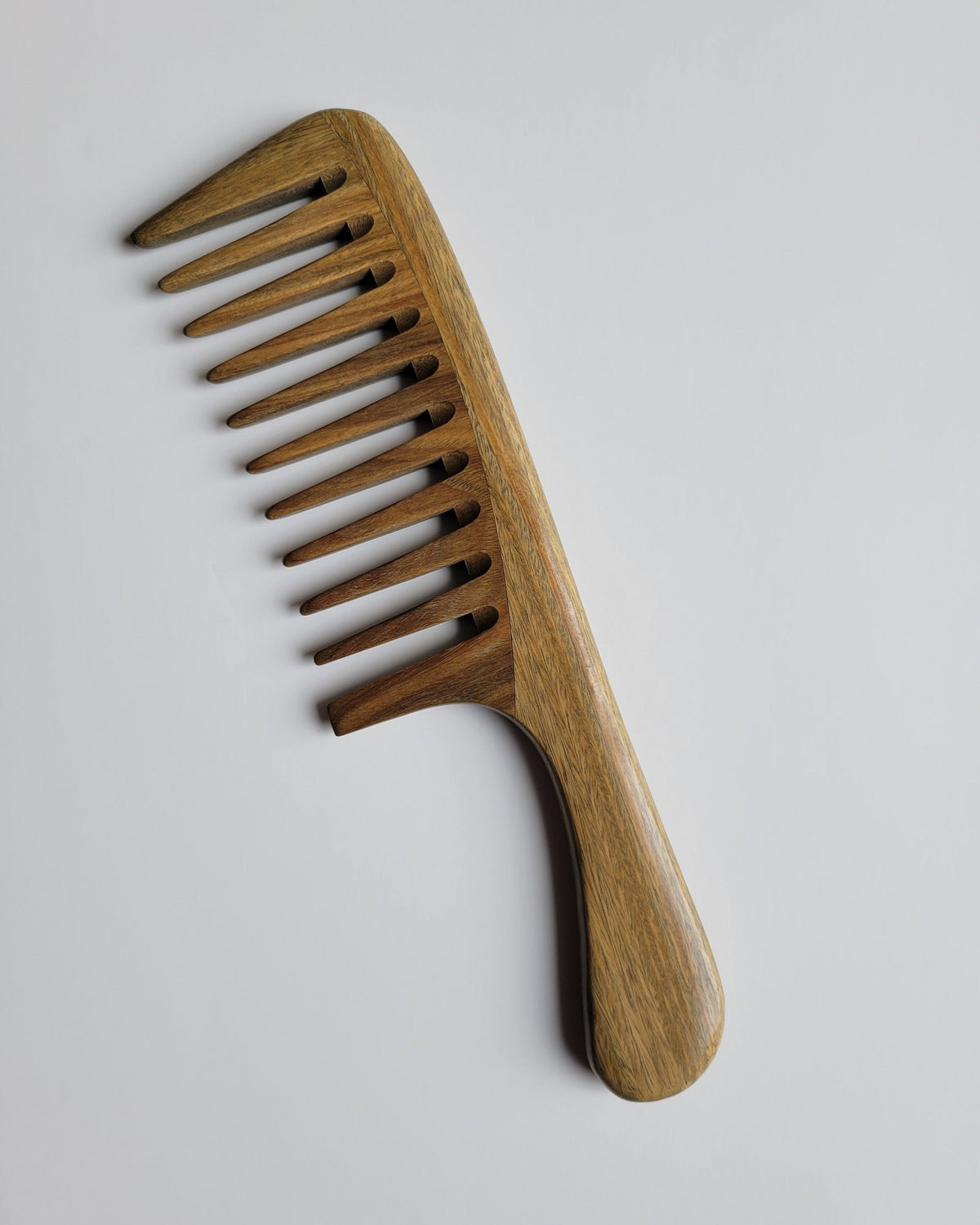 Araki Detangling Wood Comb flat view — hand-inlaid green sandalwood, wide tooth construction