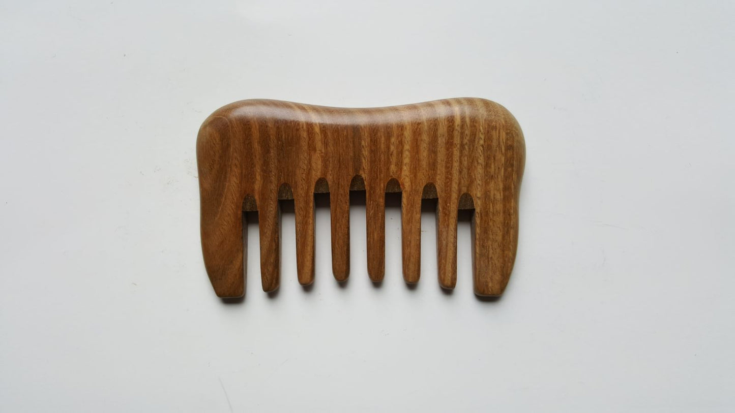 A small detangling sandalwood comb, travel size with carrying bag