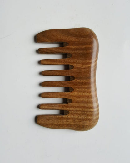 A small detangling sandalwood comb, travel size with carrying bag