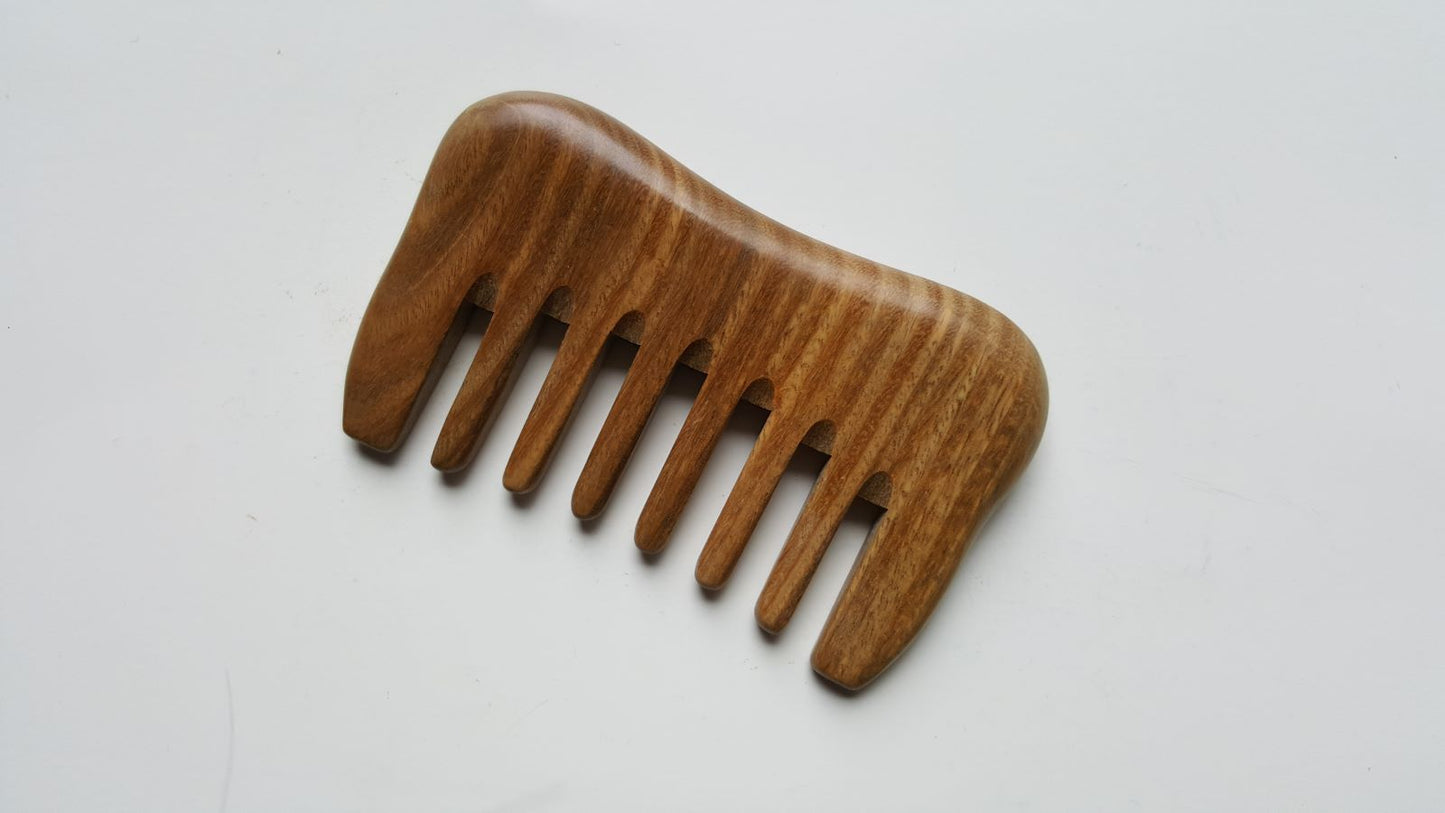 Small sandalwood comb with extra wide teeth.  Natural brown color with beautiful wood grain 