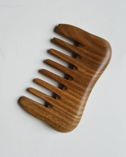 Small sandalwood comb with extra wide teeth.  Natural brown color with beautiful wood grain