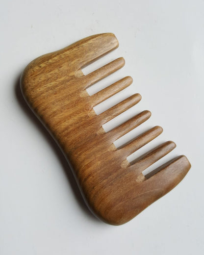 A extra wide teeth sandalwood comb designed for curly and thick hair. Comes with carrying bag and gift for her