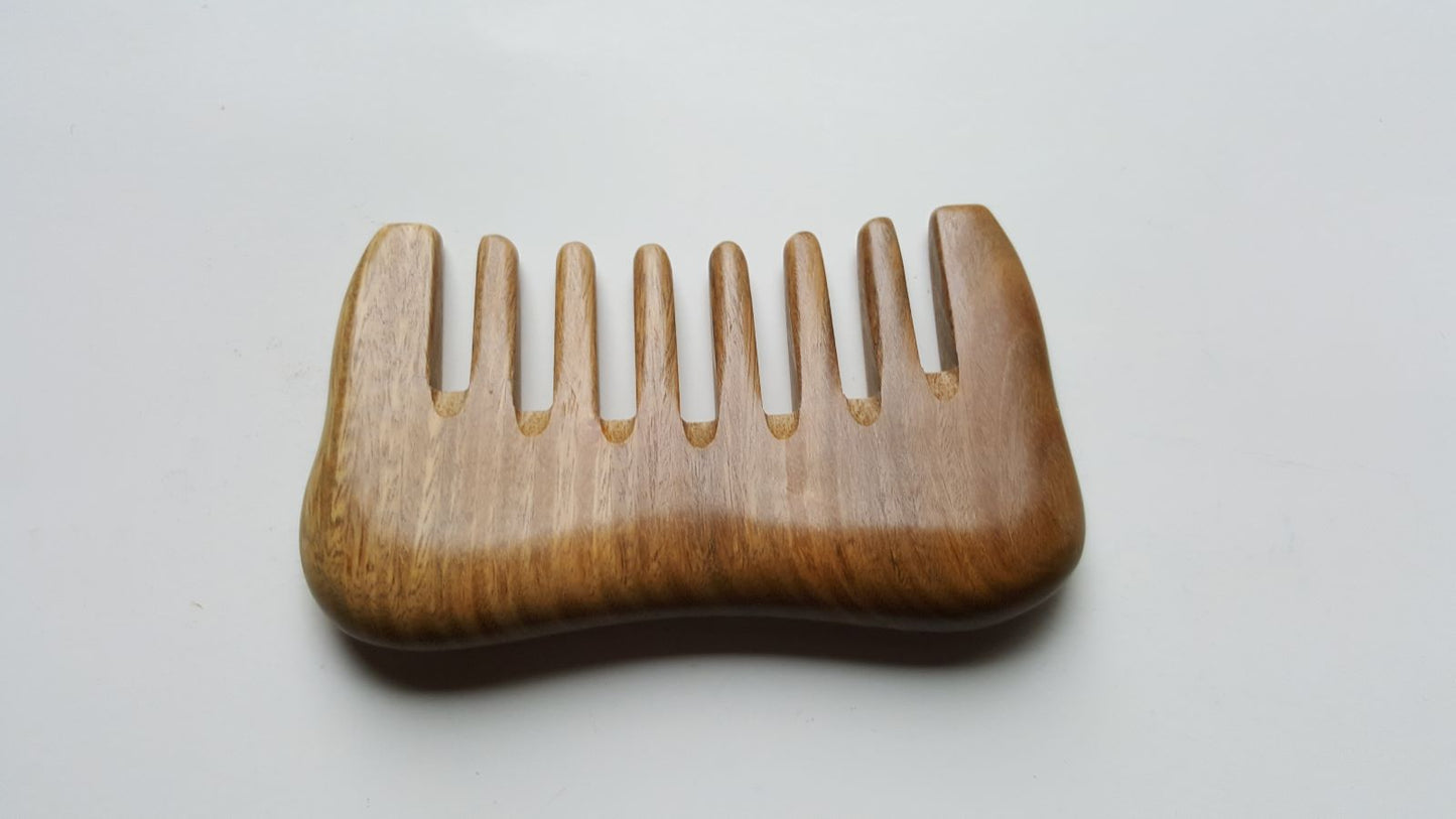 Travel size sandalwood detangling comb with extra wide teeth. anti static and anti frizz. 