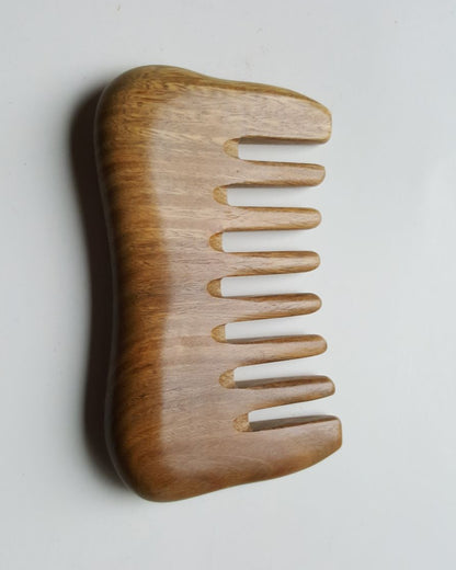 Travel size sandalwood detangling comb with extra wide teeth. anti static and anti frizz.