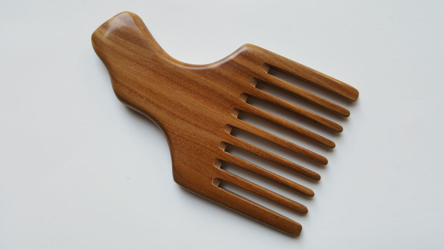 A sandalwood pick comb with a nice curved handle and a row of nine long teeth. This comb has  a natural grain pattern and is one of a kind piece.  Great gift for long hair lovers!