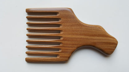 A wooden pick comb with a unique handle design. The comb has nine teeth and is made of light brown sandalwood.  Gift for love ones who grows long hair!