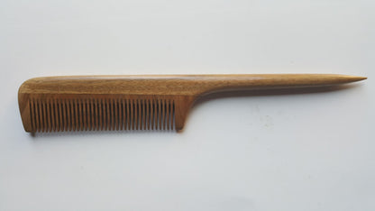  A long, wooden comb with a brown, greenish hue. The comb has a long, thin handle and a slim, rectangular comb section. it's designed for hair styling and sectioning. 