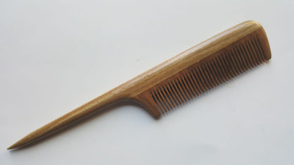 A long, thin, wooden rat tail comb with a green brown color and a fine-toothed comb on one end. The comb has a long, thin handle.  It's designed for precision sectioning. 