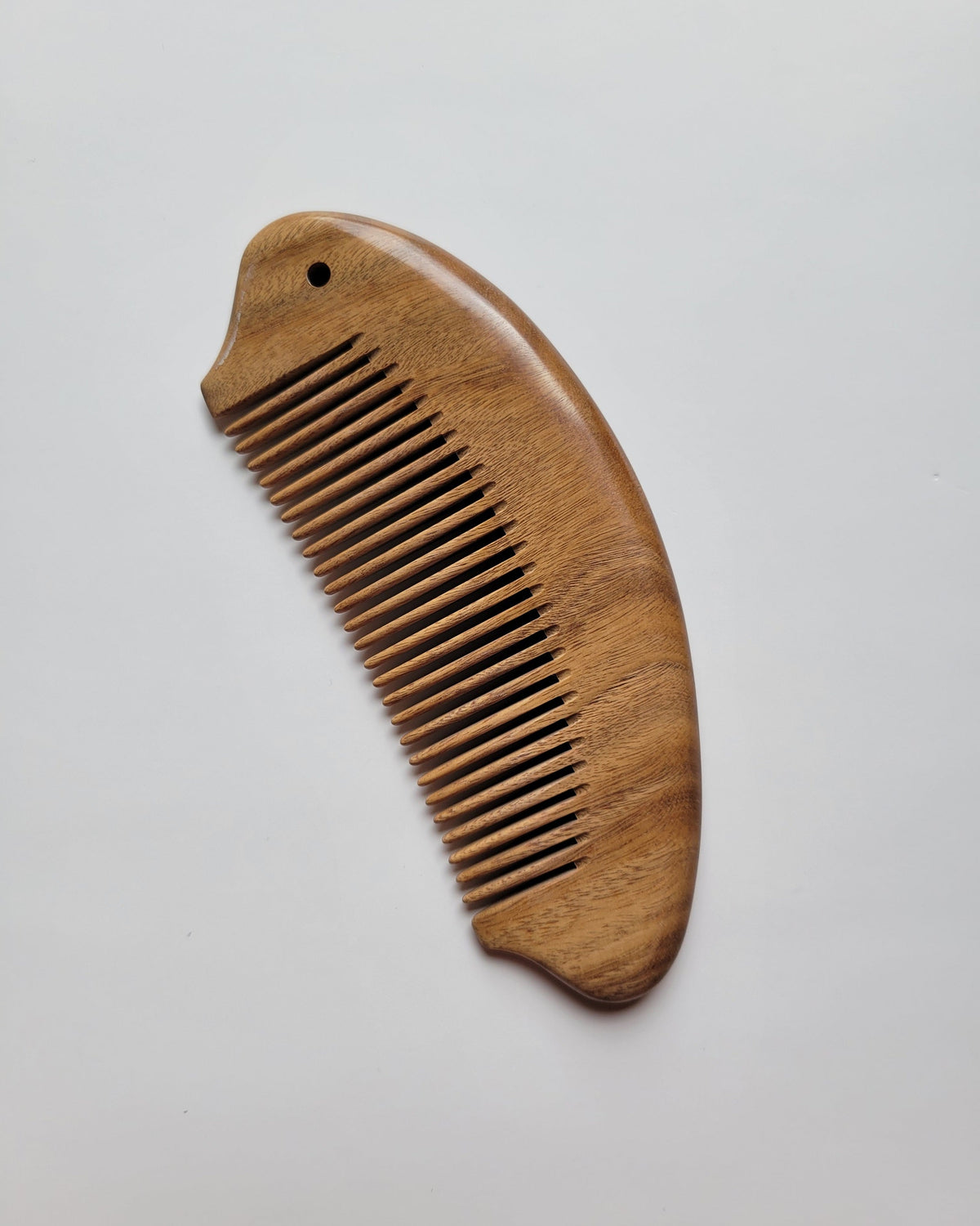 Fish shaped sandalwood comb with comfortable ergonomic grip, anti-static hardwood, distributes natural hair oils for healthy shine
