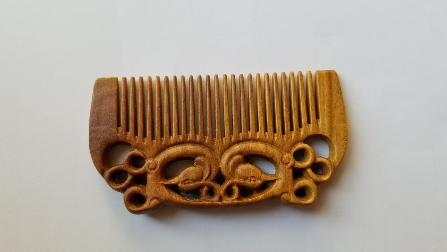 East Asian Phoenix Sandalwood Comb flat lay — overhead view showing full pocket-sized comb and hand-carved phoenix motif on both sides