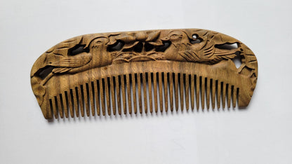 Mandarin Duck Hand Carved Sandalwood Comb flat lay — front view showing hand-carved mandarin duck pattern and fine teeth on green sandalwood
