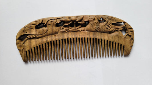 Mandarin Duck Hand Carved Sandalwood Comb flat lay — front view showing hand-carved mandarin duck pattern and fine teeth on green sandalwood