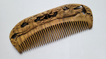 Mandarin Duck Hand Carved Sandalwood Comb flat lay — top-down view of hand-carved green sandalwood fine-tooth comb with mandarin duck pattern