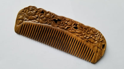 Rose Hand Carved Sandalwood Comb flat lay — side angle highlighting carved rose detail and fine tooth spacing on green sandalwood body