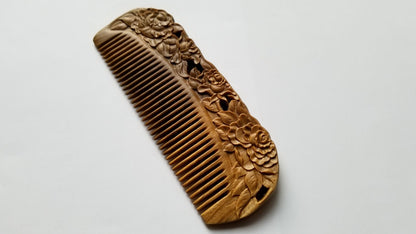 Rose Hand Carved Sandalwood Comb flat lay — top-down view of hand-carved sandalwood fine-tooth comb with blooming rose pattern