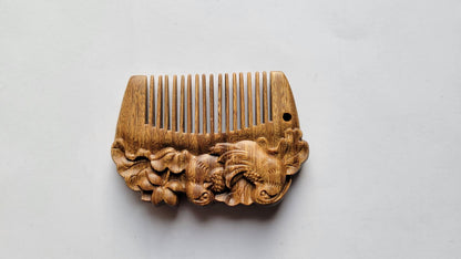 Mandarin duck hand carved comb angled left, showing carved duck motif detail on sandalwood