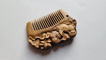 Close-up of mandarin duck carving on green sandalwood comb — hand carved detail, both sides