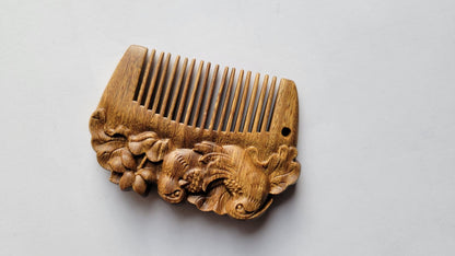 Mandarin duck hand carved comb flat lay, top view showing full symmetrical silhouette