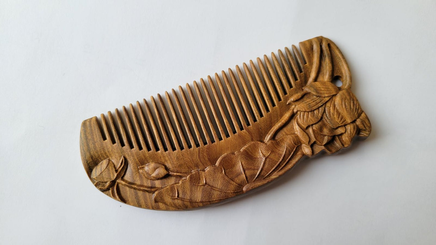 Close-up of lotus bud and leaf relief carving on brown Green Sandalwood comb — artisan Tongjing technique — Arakicrafts