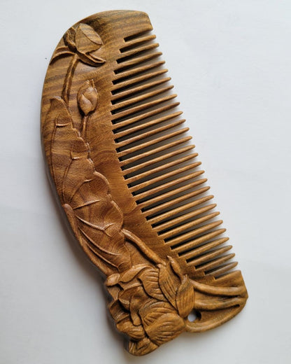 Close-up of lotus bud and leaf relief carving on brown Green Sandalwood comb — artisan Tongjing technique — Arakicrafts
