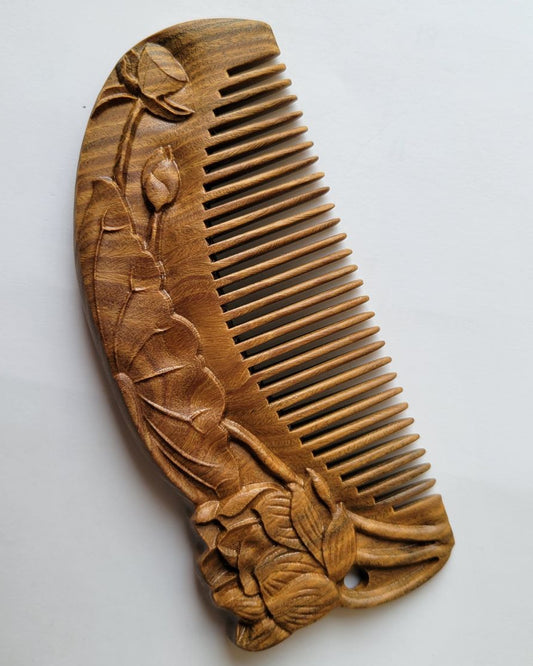 Close-up of lotus bud and leaf relief carving on brown Green Sandalwood comb — artisan Tongjing technique — Arakicrafts