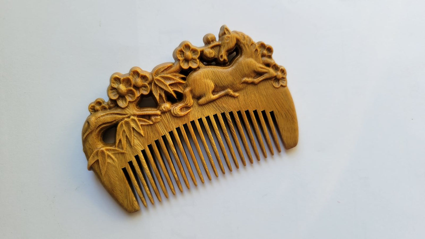 A light brown vintage style wooden comb with carving. The horse, bamboo and plums motif are on both sides of this comb. It implies "childhood sweethearts" or "a couple who grew up as childhood friends."