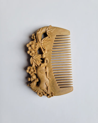 Horse bamboo plum motif hand carved sandalwood comb — underside view showing fine teeth detail