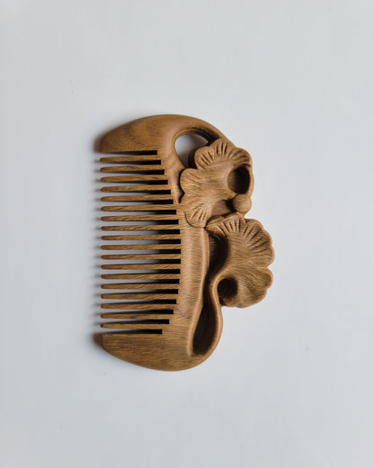 Green Sandalwood pocket comb overhead view — ginkgo leaf motif, 0.15 cm fine teeth spacing, all hair types including beard
