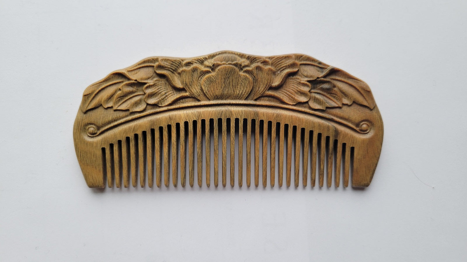 Hand carved Green Sandalwood pocket comb with blooming lotus and leaves relief carving, flat lay front view — Arakicrafts