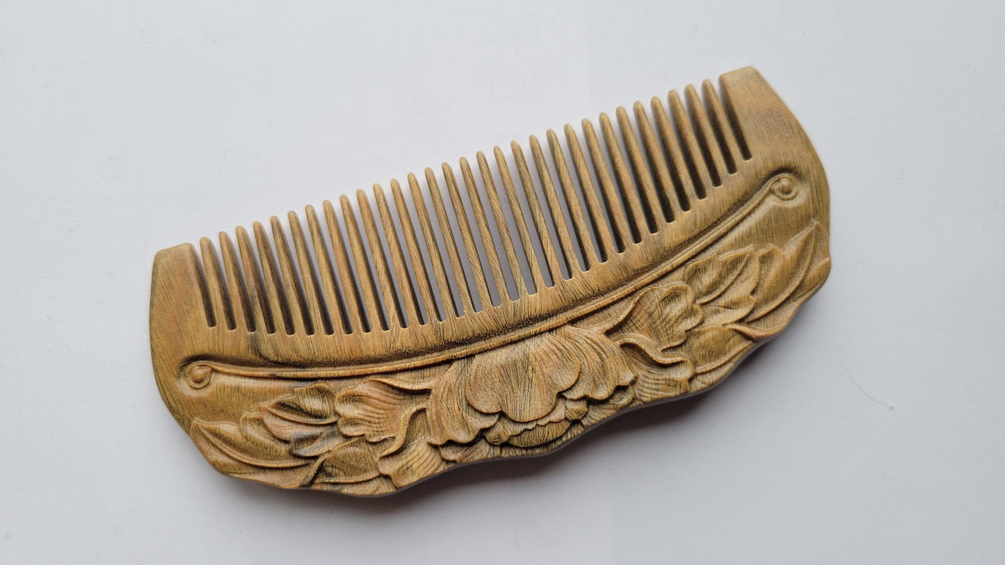 Close-up of lotus flower and leaf relief carving on Green Sandalwood comb — artisan hand carved detail — Arakicrafts